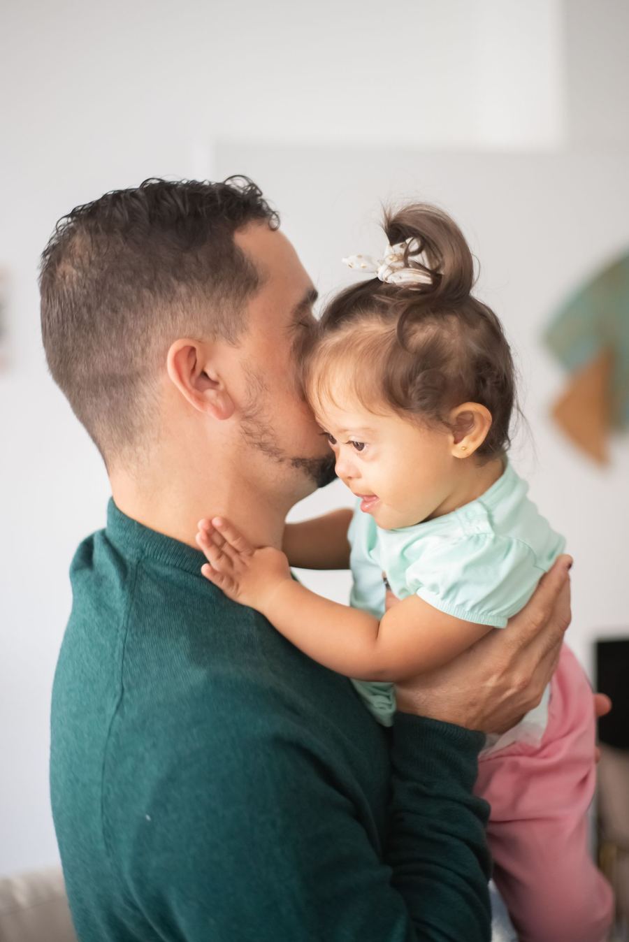 A father holding his young daughter close